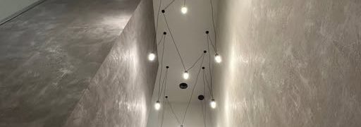 Pendant lighting on a double-height wall